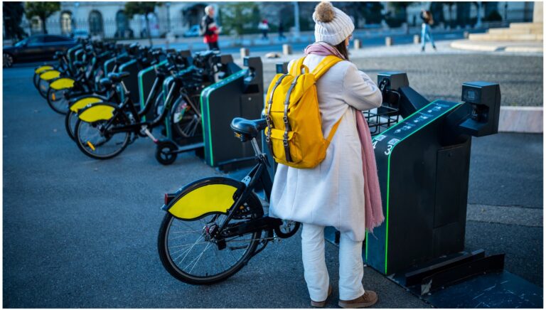 Donna che noleggia una bici a favore della mobilità sostenibile in Italia