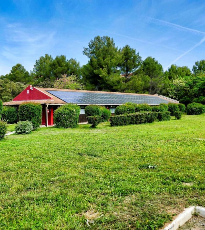 vertical-shot-small-house-with-solar-panels-green-field-canary-islands